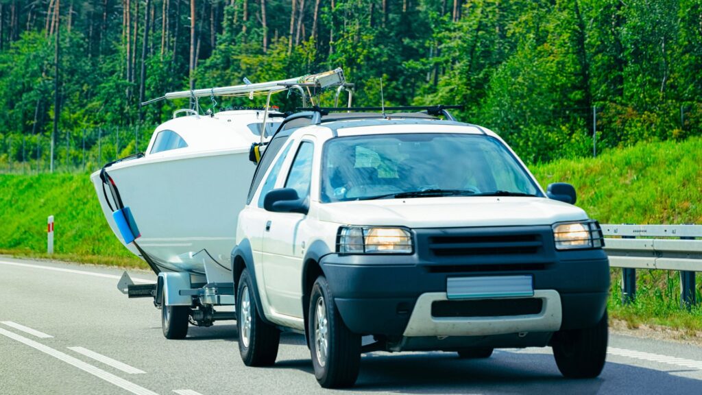 Vehicle pulling boat on trailer