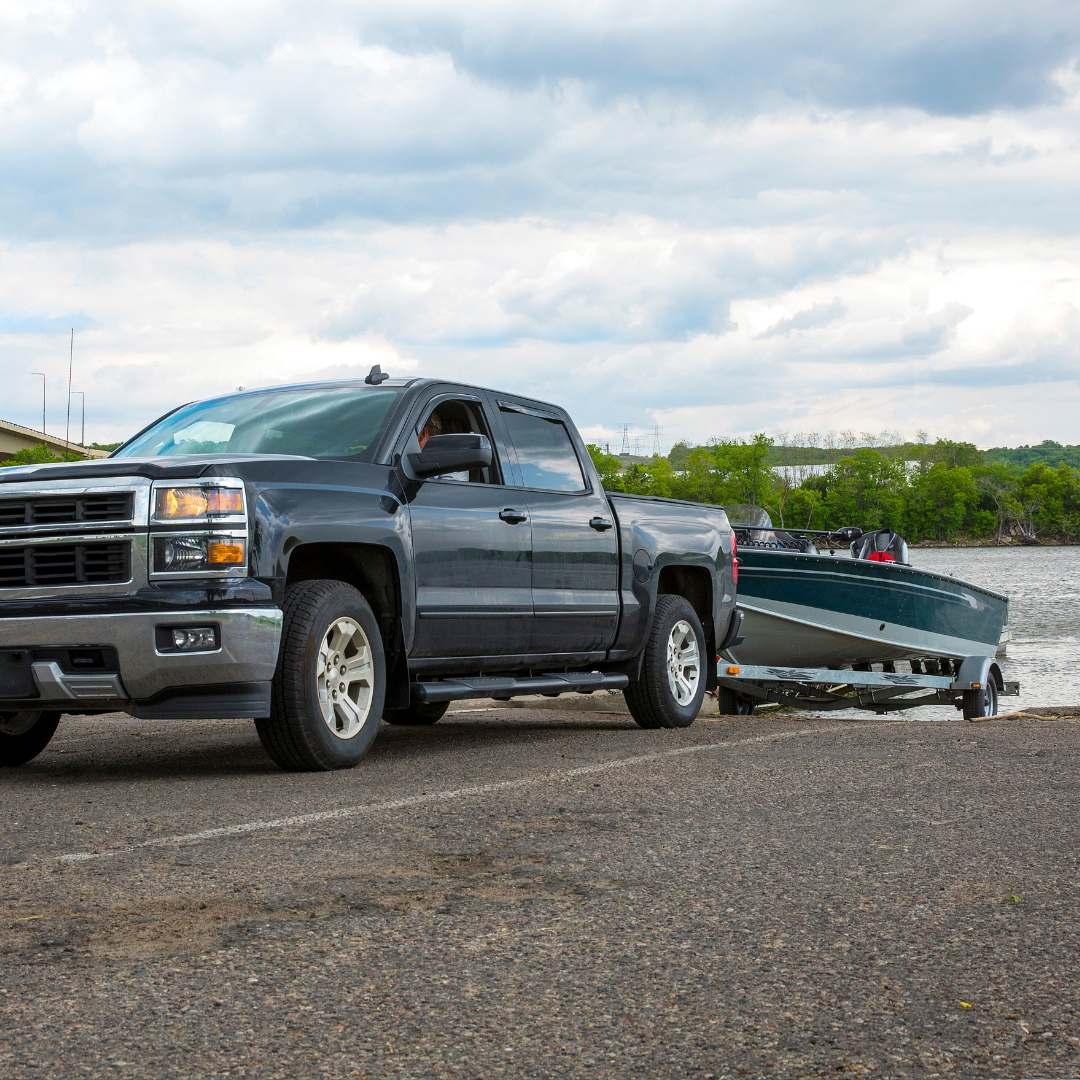 truck pulling a boat out of water on a trailer